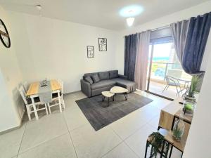 a living room with a couch and a table at EilatCasa in Eilat