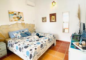 a bedroom with a bed with a stuffed animal on it at Casita Acacia in Viñuela