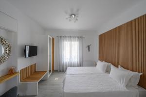 a bedroom with a large bed and a tv at Marvarit Villas in Vóthon