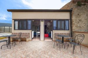 a patio with tables and chairs in front of a building at Antica Dimora Marinelli in Ficarra