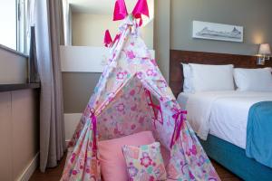 a tent in a bedroom with a bed at Sol Ipanema Hotel in Rio de Janeiro