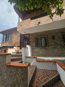 a brick building with stairs and benches in front of it at Casa luz in Medellín
