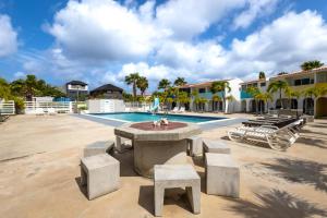 a courtyard with a fountain in front of a building at Lighthouse Beach Resort with Ocean View in Kralendijk