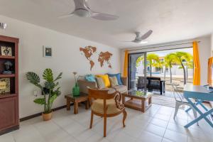 a living room with a couch and a table at Lighthouse Beach Resort with Ocean View in Kralendijk