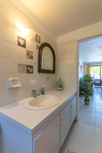 a bathroom with a sink and a mirror at Lighthouse Beach Resort with Ocean View in Kralendijk