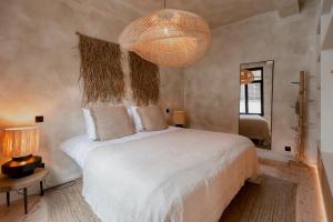 a bedroom with a bed and a large chandelier at BTFL Living Antwerp in Antwerp +175 photos