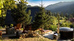 a backyard with a hot tub and trees and a fence at Valley Hills-котедж на схилах гір з чаном-джакузі in Slavske
