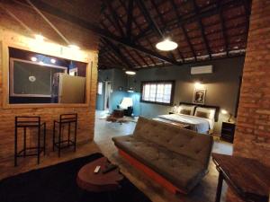 a living room with a couch and a bed at Loft Industrial in Santo André