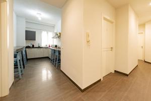 a large room with a kitchen and a hallway at Celeste Affittacamere in Cefalù