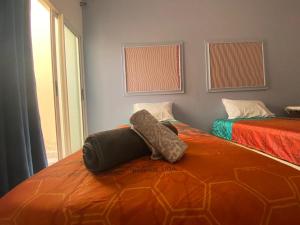 a bedroom with two beds and a window at DAR SHaMSY in Souani