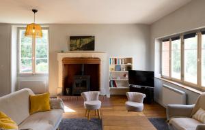 a living room with a couch and a fireplace at Moulin XVe siècle - Gîte privatif 8 pers - Rivière - Châteaux de la Loire in Vineuil