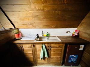 a small kitchen with a sink and a counter at La Encantada Cabañas in Cajamarca