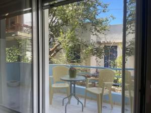 a patio with a table and chairs on a balcony at Stelios apartment 1 in Chios