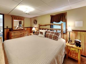 a bedroom with a bed and a dresser and a mirror at Coopers Landing in Swanton