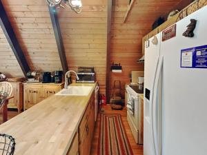 a kitchen with a sink and a refrigerator at Coopers Landing in Swanton