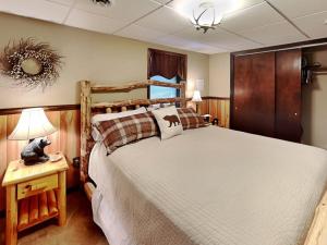 a bedroom with a large bed with a wooden headboard at Coopers Landing in Swanton +27 photos