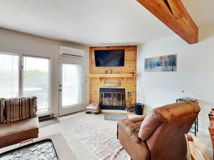 a living room with a couch and a fireplace at Deep Creek Village #31 in McHenry