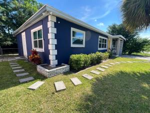 a blue house with stepping stones in front of it at Pura Vida Private Access, Room & Bathroom in West Palm Beach