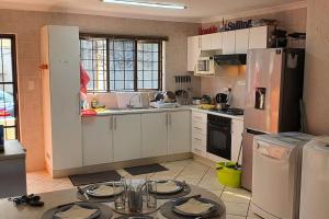a kitchen with a table with plates on it at Die Ankers - Apartment 12 in Margate