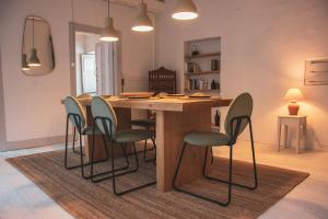 a kitchen with a wooden island with chairs around it at Douro Bay House in Riba Douro