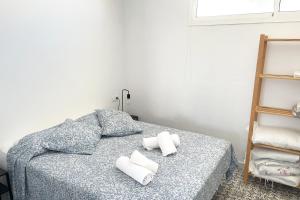 a bedroom with a bed with two pillows on it at Agoodplan Aitana Playa El Palmar in El Palmar