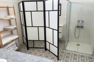 a shower with a glass door in a bathroom at Agoodplan Aitana Playa El Palmar in El Palmar