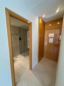 a hallway with a glass door and a walk in shower at AT home Avenida del Ejercito in Guadalajara +50 photos