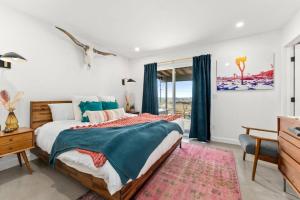 a bedroom with a large bed and a window at Soul Shine - Gorgeous Views - Modern - NEW in Joshua Tree