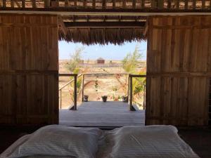 a bed in a wooden room with a view at Lar Torus Eco Lodge - Kite is Surf in Tatajuba