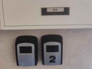 two gray and black calculators sitting under a counter at Fairwinds - Double Room with Ensuite - Luqa Airport - Self Check In & Out available in Luqa