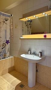 a bathroom with a sink and a shower and a mirror at Sea House Lahania in Lachania