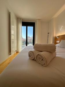 a hotel room with a bed with towels on it at AT home Santo Domingo in Guadalajara