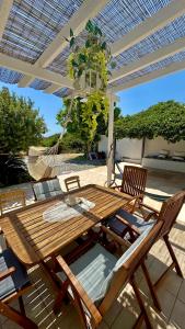 a wooden table and chairs on a patio at Sea House Lahania in Lachania