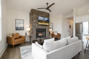 a living room with a couch and a fireplace at Franklin On Main in Blowing Rock