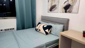 a bed with two pillows on it in a room at Casa de Teresa in Manila