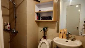a small bathroom with a toilet and a sink at Casa de Teresa in Manila +8 photos