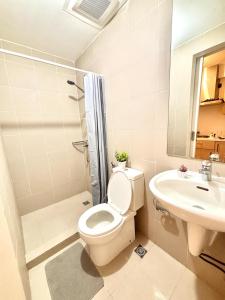 a bathroom with a toilet and a sink at Casa de Teresa in Manila
