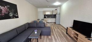 a living room with a couch and a flat screen tv at Home VIZA - 2 in Yambol