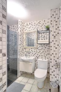 a bathroom with a toilet and a sink at Elegant apartment in Old town Vilnius SELF CHECK IN 24x7 by H&H in Vilnius