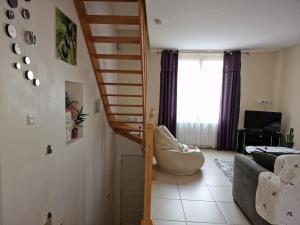 a living room with a spiral staircase in a house at duplex en maison individuelle de 70 m2avec jardin in Viry-Châtillon