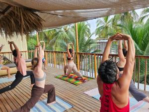 a group of people doing yoga on a deck at Natyva House in Guachaca