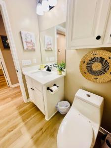 a bathroom with a white toilet and a sink at Eastgate 22A in Hammond +33 photos