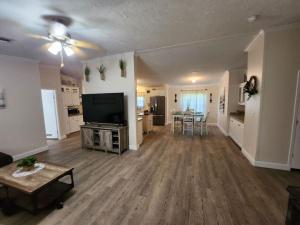 a large living room with a television and a table at Thomas House in Hammond