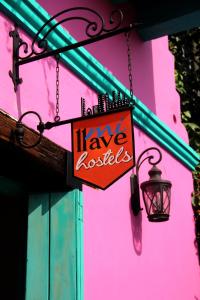 a sign that says have roosters hanging from a building at Mi Llave Hostels Cartagena in Cartagena de Indias