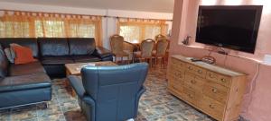 a living room with a couch and a flat screen tv at Vikendica Sofia in Žagubica