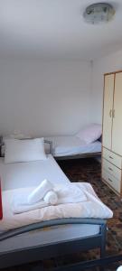 a bedroom with two beds and a dresser at Vikendica Sofia in Žagubica