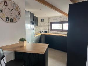 a kitchen with a large clock on the wall at YucaJaus in Teguise