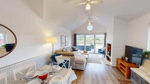 a living room with a couch and a tv at Prospect Lodge at The Bay Filey, sleeps up to 6, and 2 dogs stay for free! in Filey