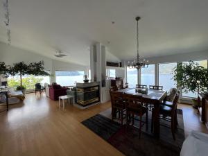 a kitchen and living room with a table and chairs at Whales house in Horseshoe Bay +124 photos