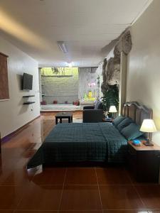 a bedroom with a bed and a living room at شقة استوديو in Abḩur al Janūbīyah